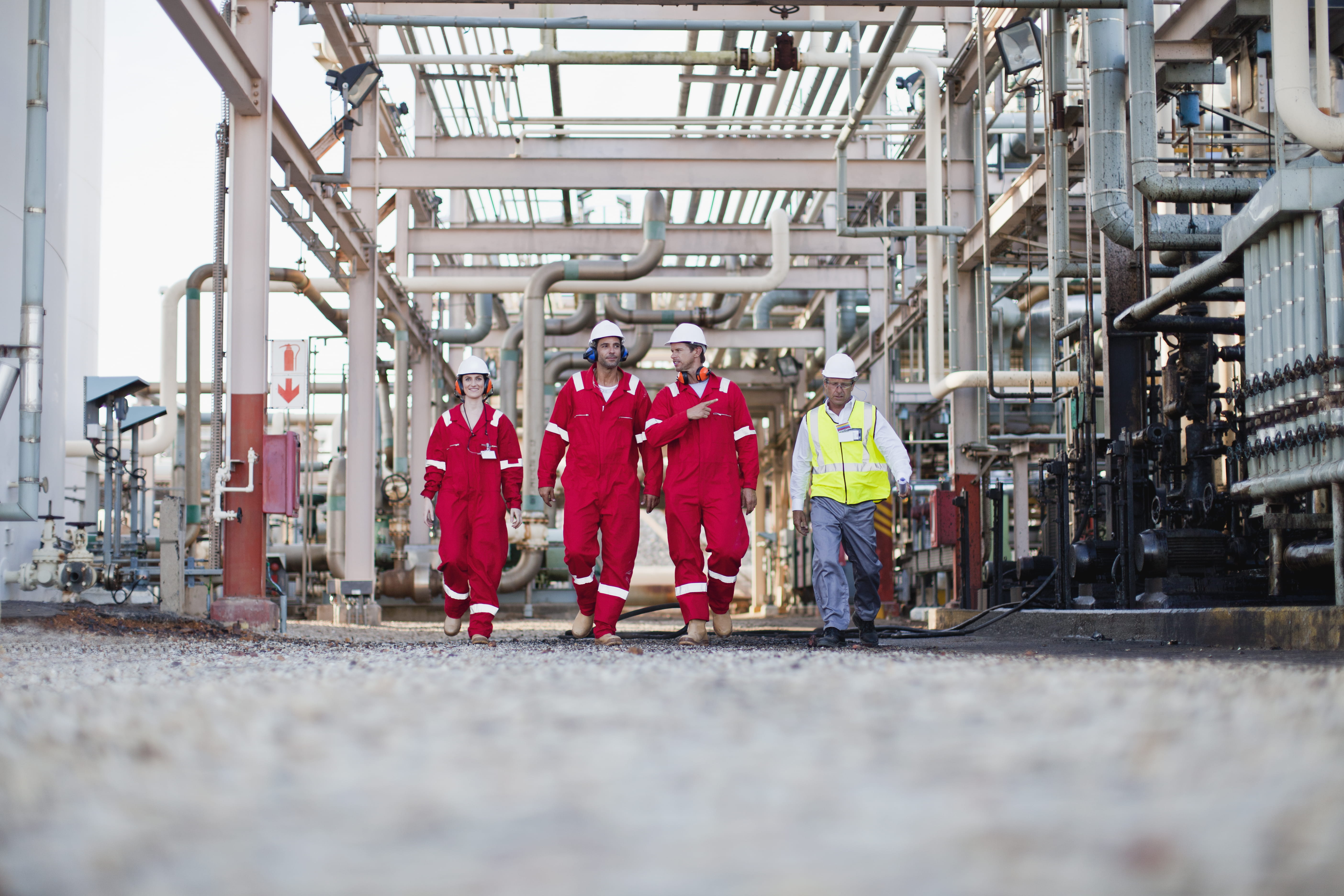 engineers walking towards camera in chemical plant