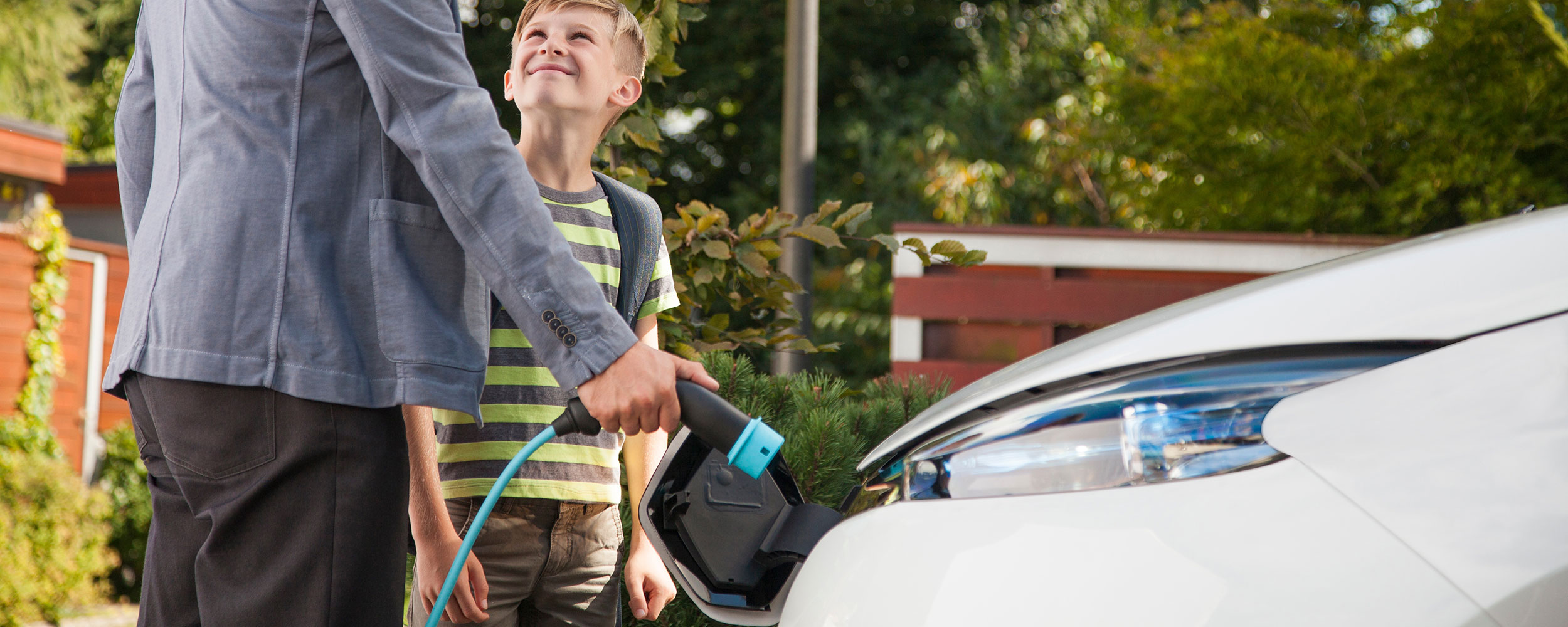 Man charging electric vehicle