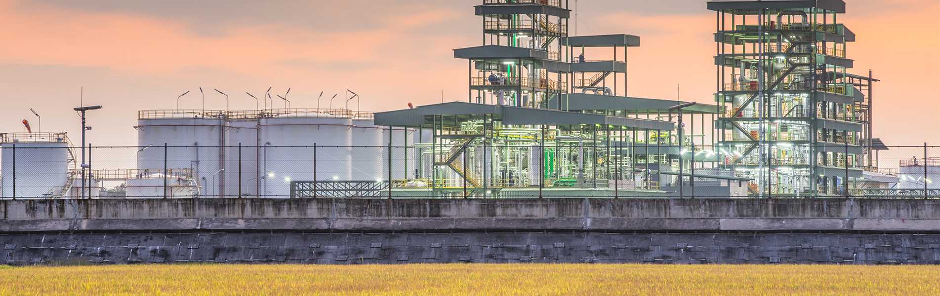 Renewable diesel refinery against an orange sky.