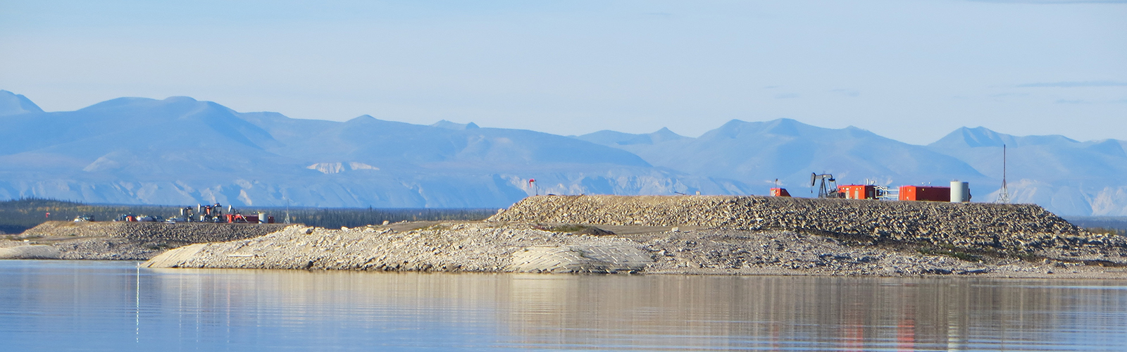 Oil Rig Islands on the Mackenzie River in Norman Wells with jack pumps.